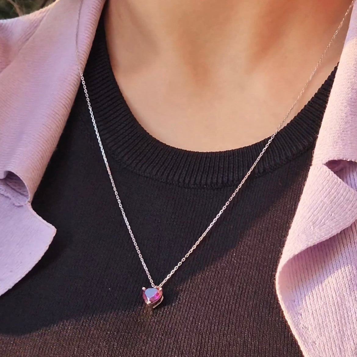 Purple heart pendant on a silver chain, front view