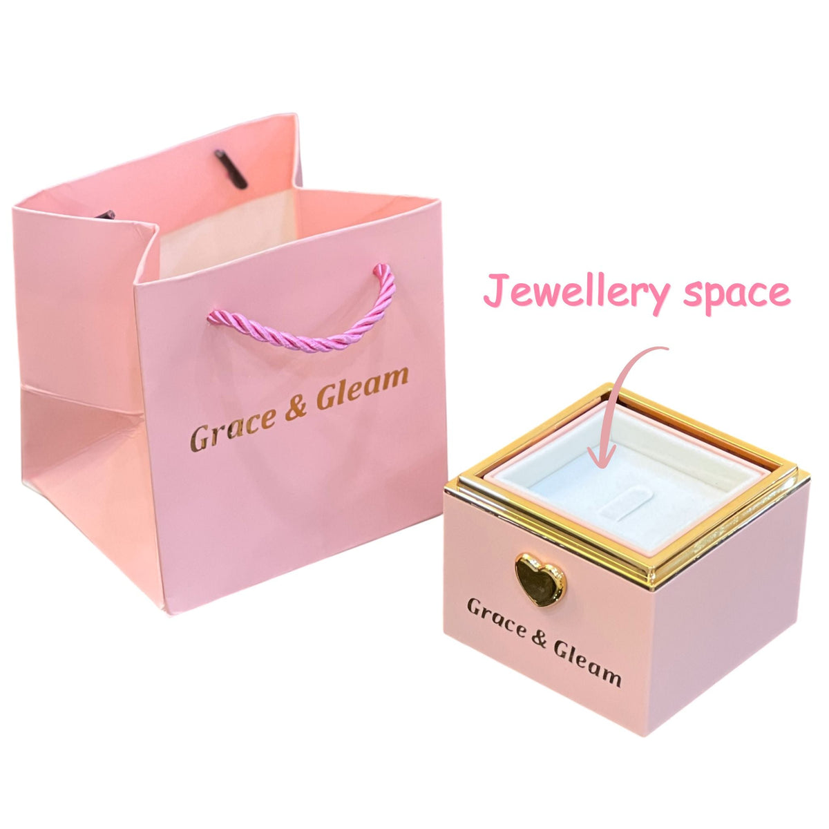 Candle-lit birthday box rotated open to reveal velvet ring slot, with pink gift bag