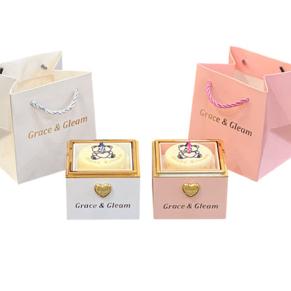 Candle-lit birthday box in white and pink with matching Grace & Gleam gift bags