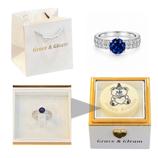 White candle-lit birthday cake gift box with ocean blue ring and Grace & Gleam gift bag Pakistan
