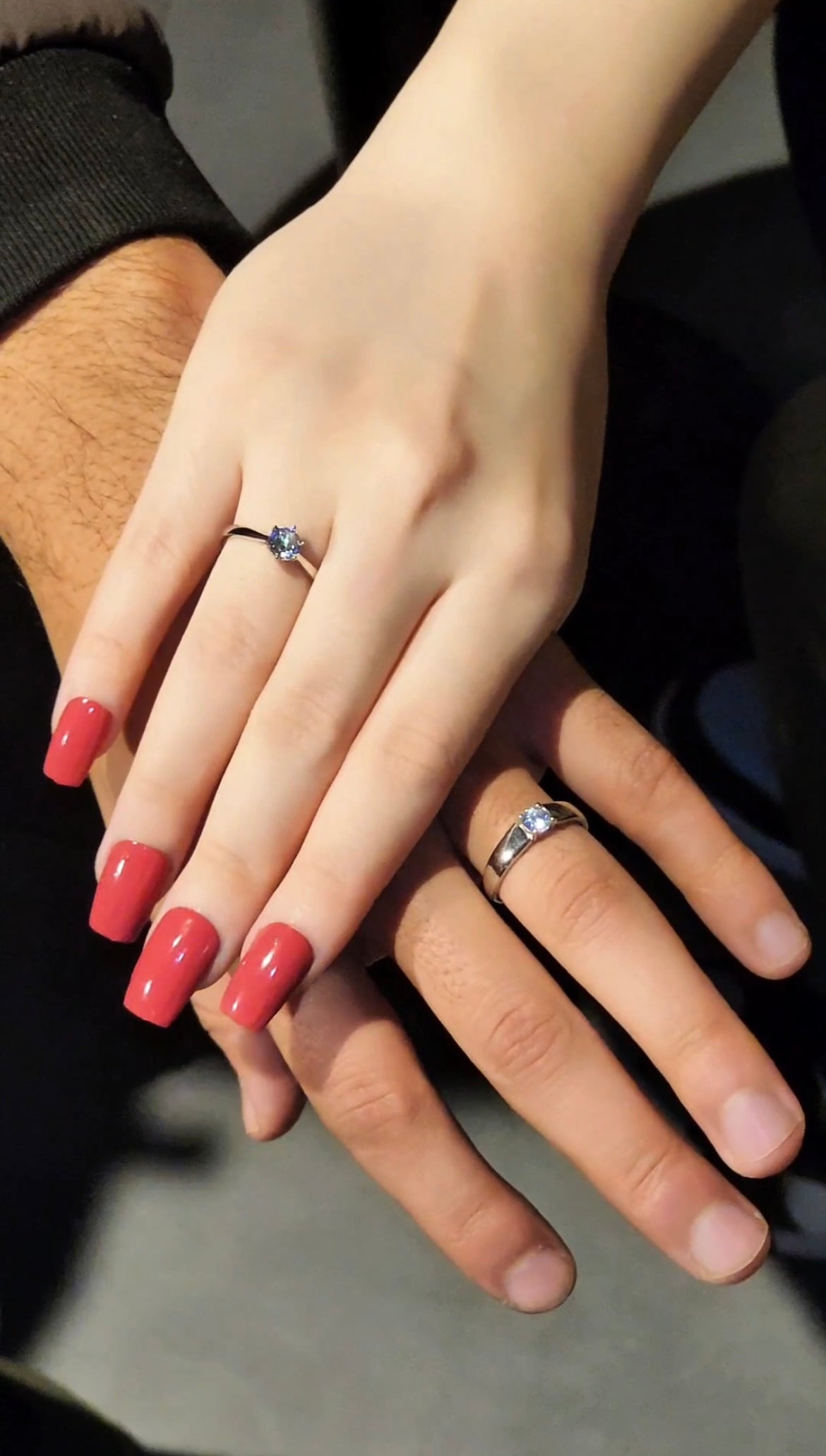 Couple wearing matching silver promise rings