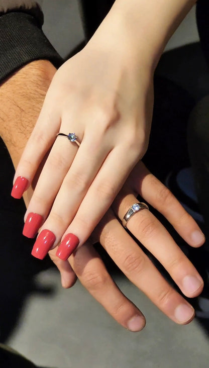 Couple wearing matching silver promise rings
