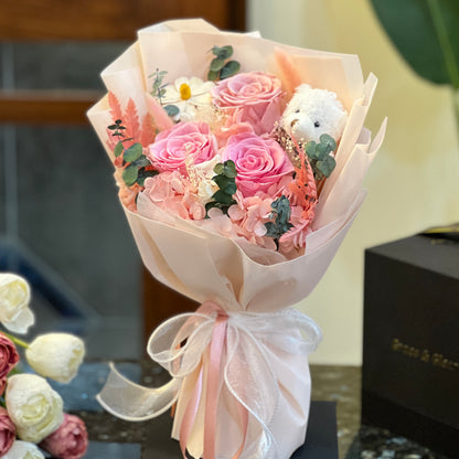 Pink preserved rose bouquet with a teddy bear, hand-wrapped