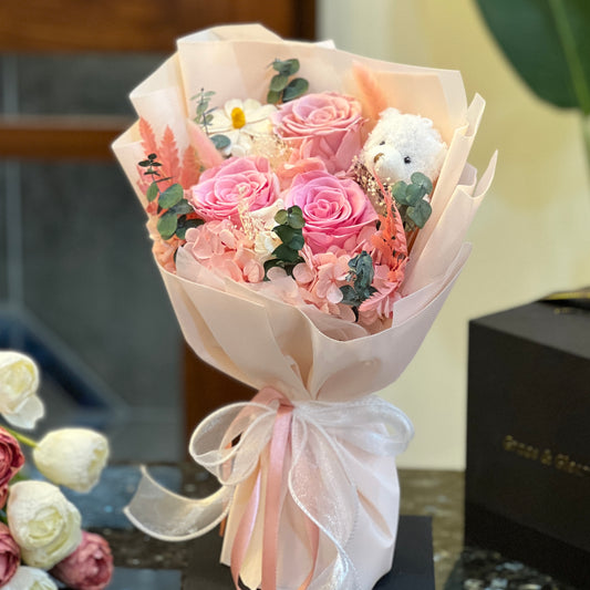 Pink preserved rose bouquet with a teddy bear, hand-wrapped