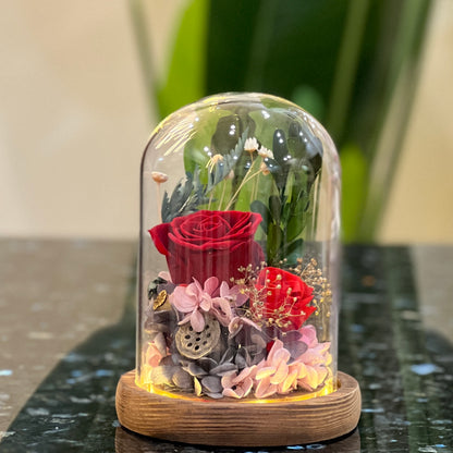 Red forever flowers dome glowing under LED - preserved red roses, hydrangea and greenery
