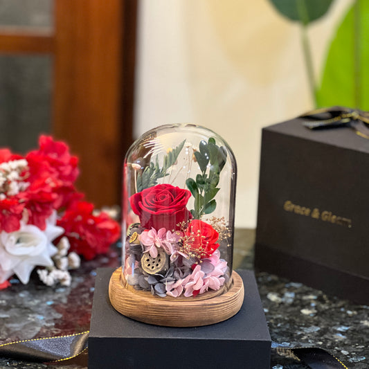 Red forever flowers dome - preserved red roses and hydrangea under a glass dome beside a Grace & Gleam gift box