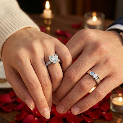 Couple hands wearing One Love silver couple rings with heart ring for women and matching band for men