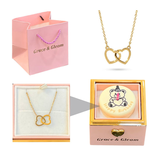 Pink candle-lit birthday cake gift box with double heart necklace and Grace & Gleam gift bag Pakistan