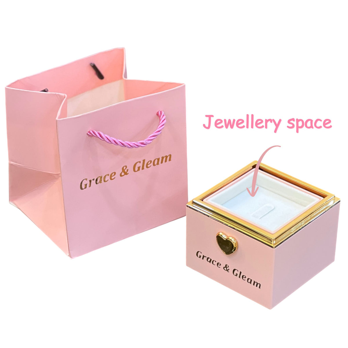 Surprise birthday gift box rotated open to reveal hidden ring slot, with pink gift bag